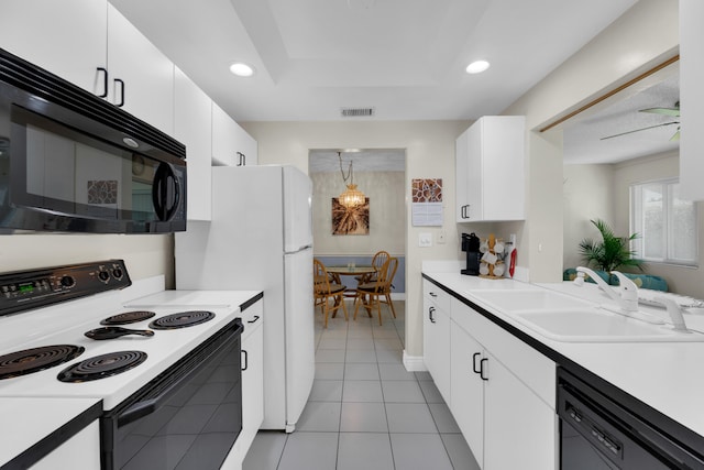 kitchen with white cabinets, black appliances, light tile patterned flooring, and sink