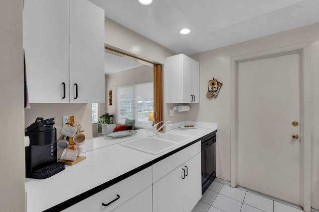 kitchen with white cabinets, dishwasher, light tile patterned floors, and sink