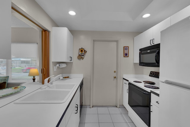 kitchen featuring white appliances, white cabinetry, light tile patterned flooring, and sink