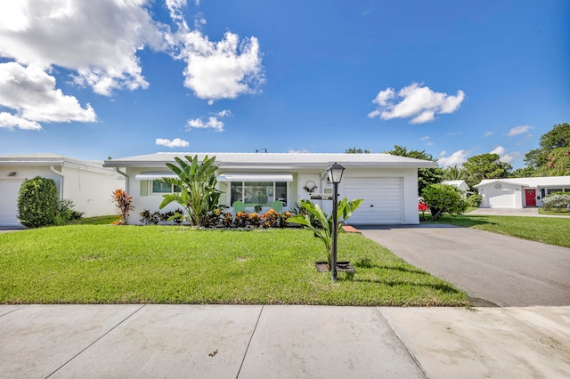 ranch-style house featuring a front yard and a garage