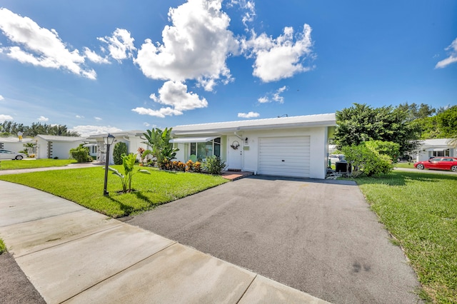 ranch-style house with a front lawn and a garage