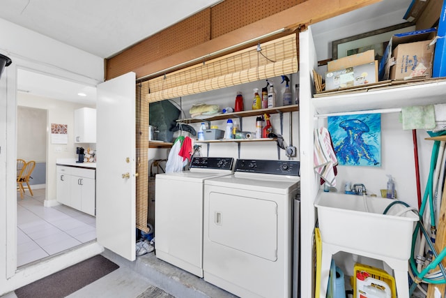 washroom with light tile patterned floors, separate washer and dryer, and sink