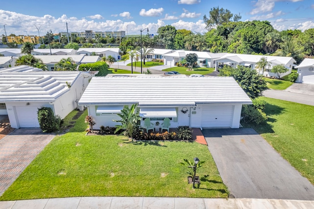 view of front of property with a garage and a front yard