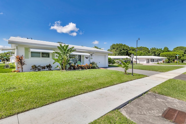 single story home with a front yard and a garage