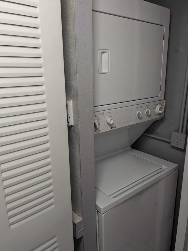 laundry room with stacked washer / drying machine