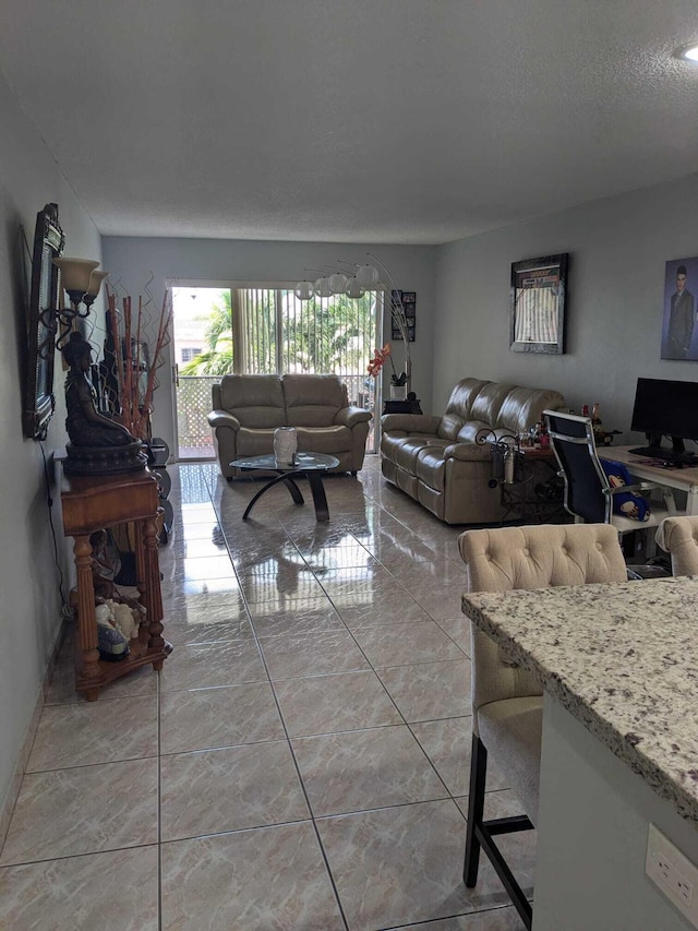 interior space with a textured ceiling and light tile patterned flooring