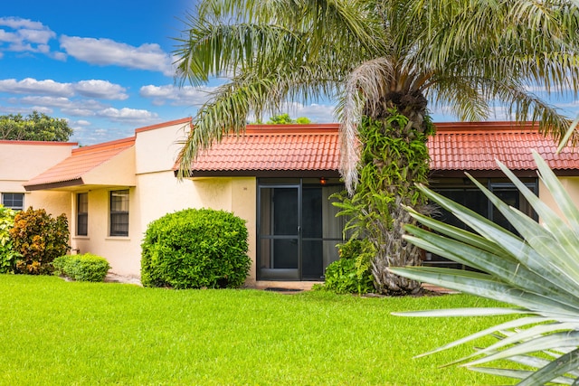 rear view of property with a lawn