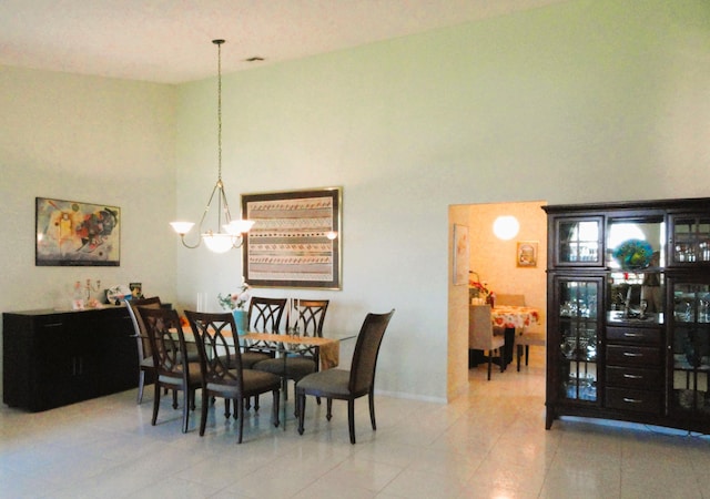 dining space featuring an inviting chandelier and light tile patterned floors