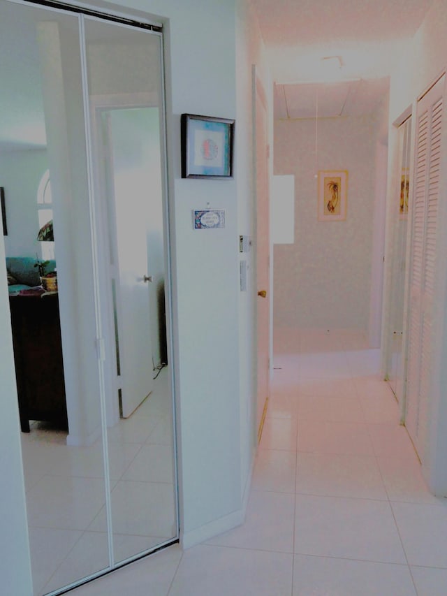 corridor with light tile patterned floors