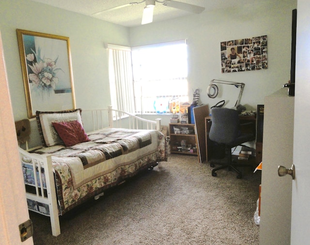 carpeted bedroom with a textured ceiling and ceiling fan