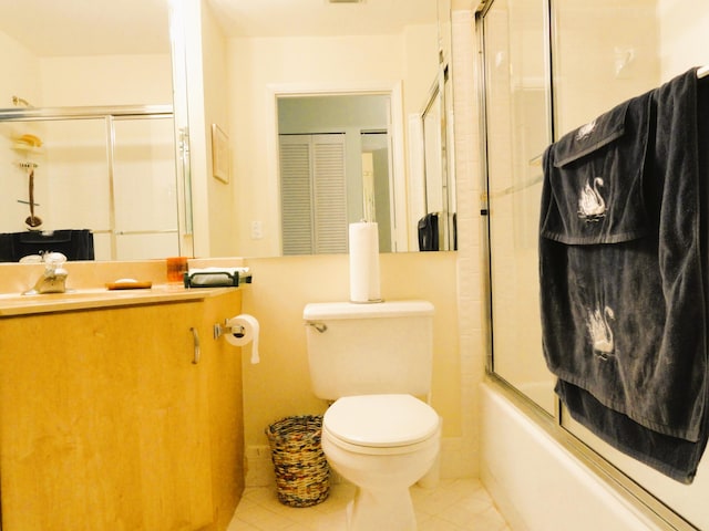 full bathroom with shower / bath combination with glass door, toilet, vanity, and tile patterned floors