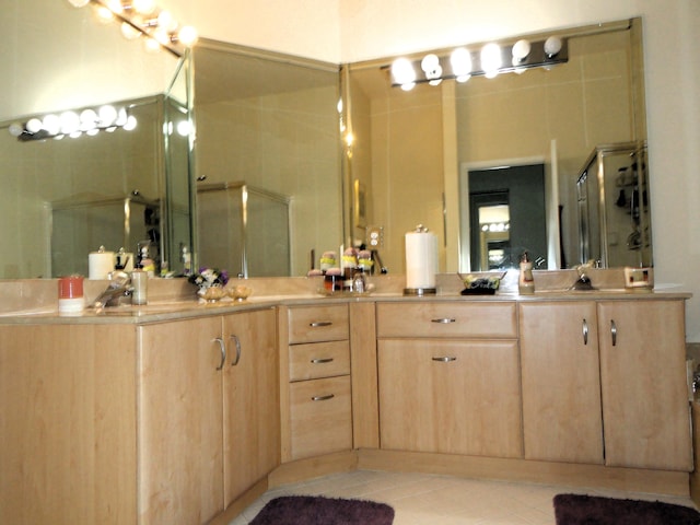 bathroom featuring vanity, tile patterned floors, and an enclosed shower