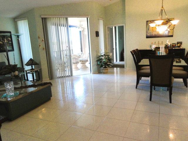 tiled dining area featuring a chandelier