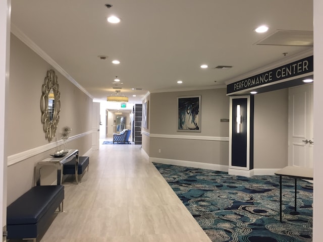 hallway featuring crown molding