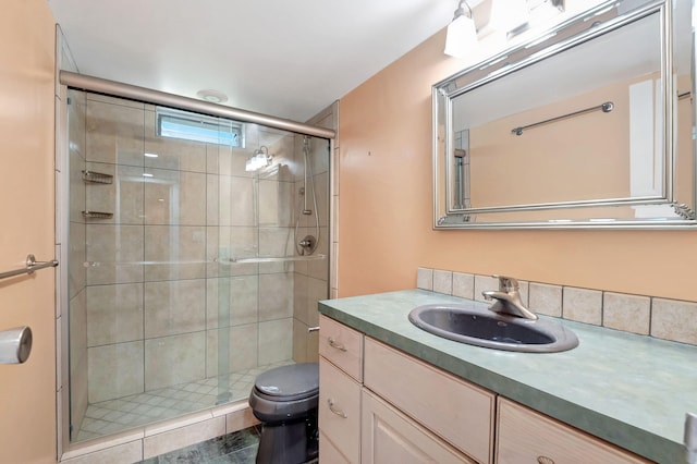 bathroom featuring tile patterned flooring, vanity, toilet, and an enclosed shower