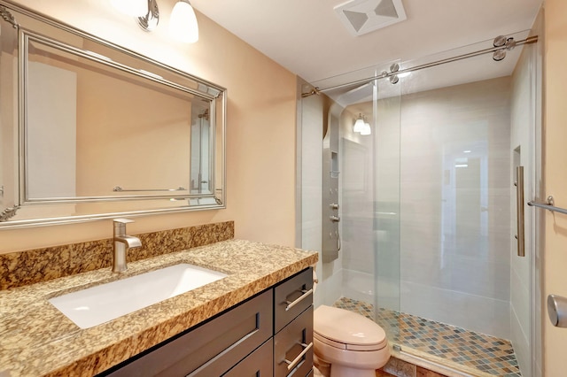 bathroom with vanity, toilet, and an enclosed shower