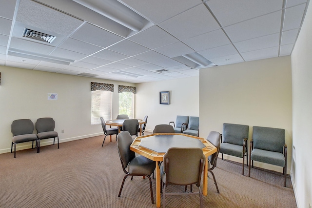 dining room with carpet floors and a paneled ceiling