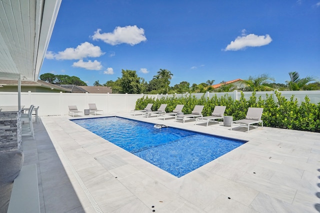 view of swimming pool featuring a patio area