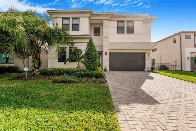 view of front of property with a front lawn and a garage