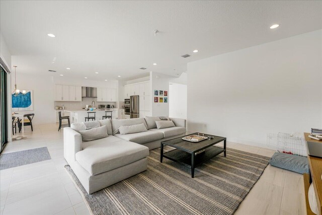 living room with a towering ceiling and tile patterned flooring