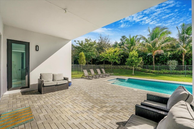 view of swimming pool with an outdoor living space and a patio area