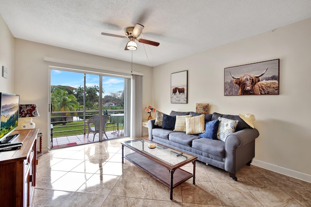 living room with a textured ceiling and ceiling fan