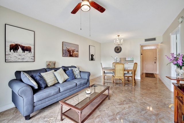 living room with ceiling fan with notable chandelier