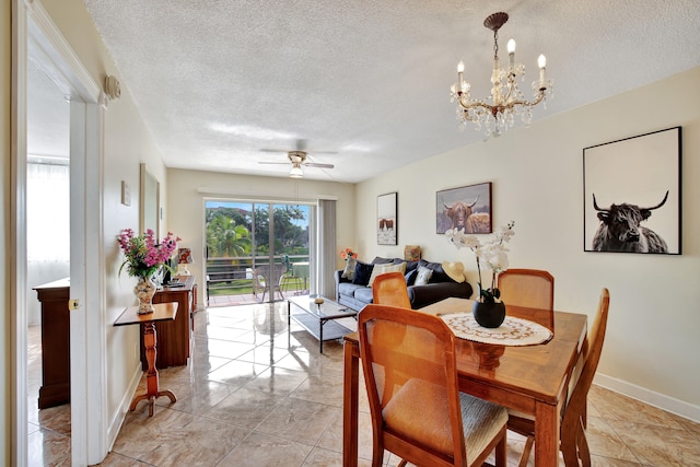 dining room featuring a textured ceiling and ceiling fan with notable chandelier