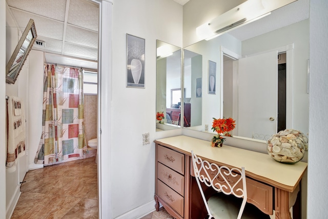 bathroom featuring a healthy amount of sunlight, tile patterned flooring, vanity, and toilet