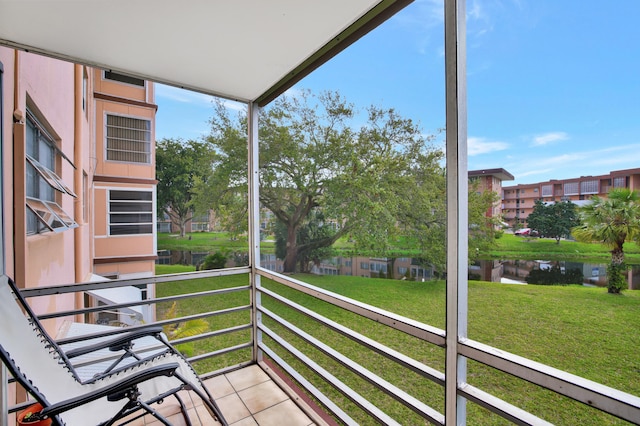 unfurnished sunroom with a healthy amount of sunlight and a water view