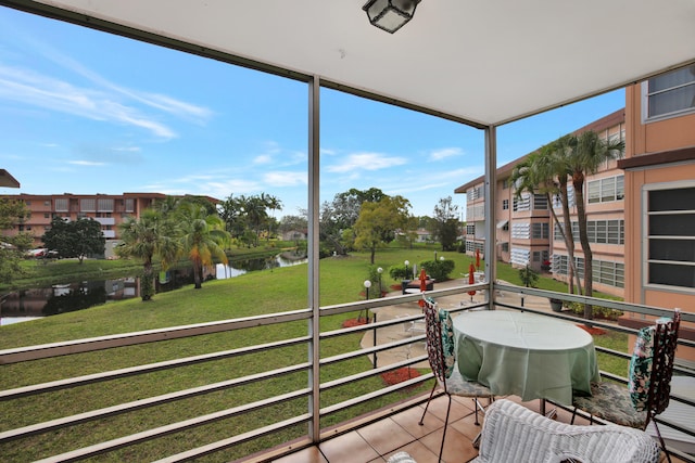 sunroom / solarium with a healthy amount of sunlight and a water view