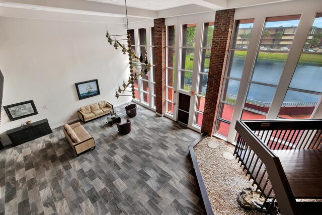 living room with a water view and dark hardwood / wood-style flooring