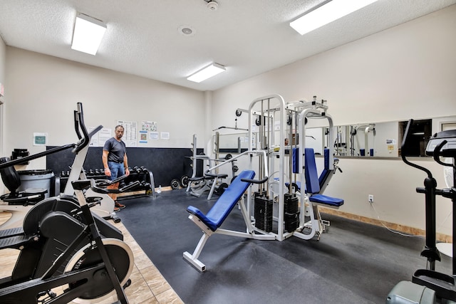 exercise room featuring a textured ceiling