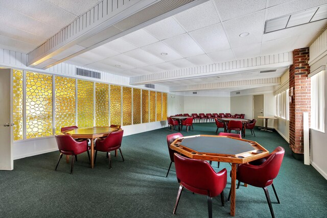 game room featuring a drop ceiling and carpet