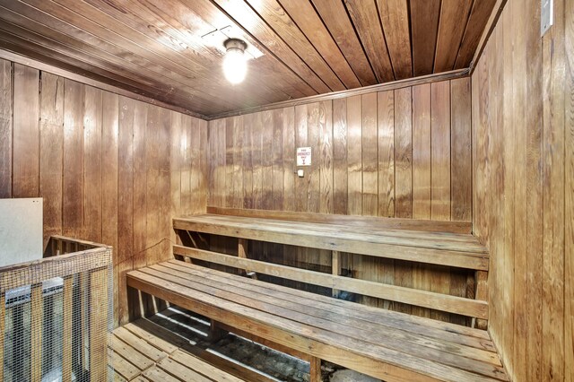 view of sauna featuring wood walls, hardwood / wood-style floors, and wooden ceiling