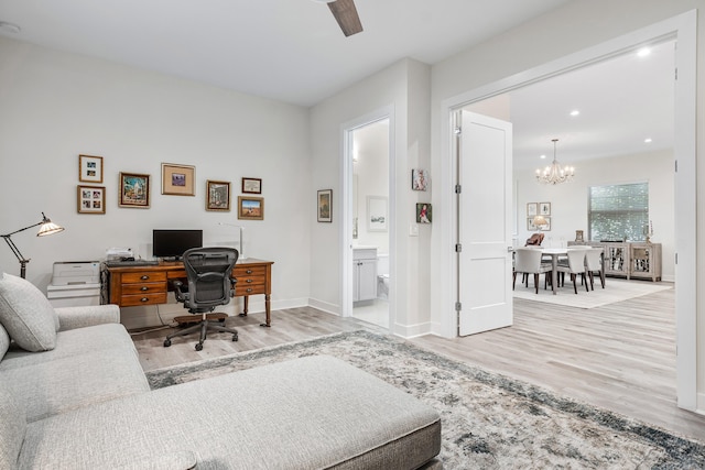 office with a notable chandelier and light hardwood / wood-style flooring