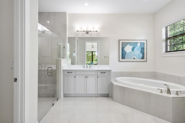 bathroom with vanity, shower with separate bathtub, and tile patterned floors