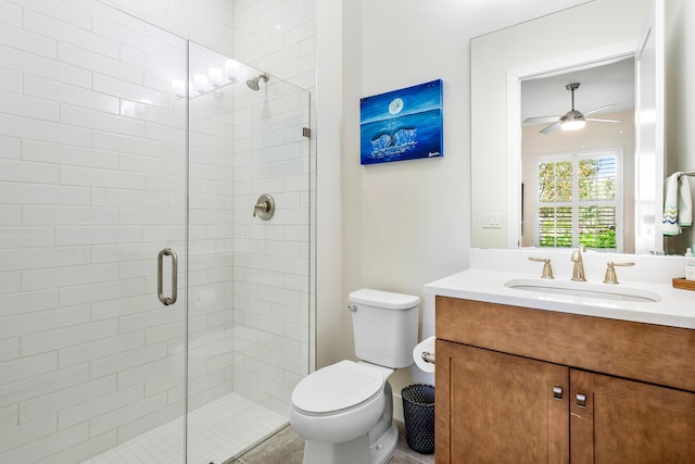 bathroom featuring ceiling fan, toilet, walk in shower, and vanity