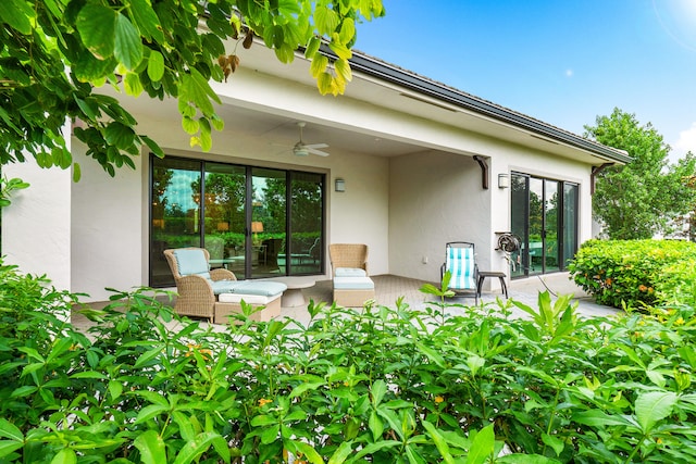 exterior space with ceiling fan and a patio area