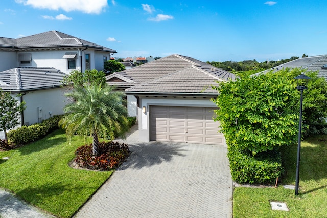 view of front of house with a front yard and a garage