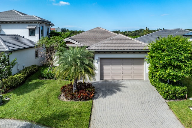 view of front of property with a garage and a front lawn