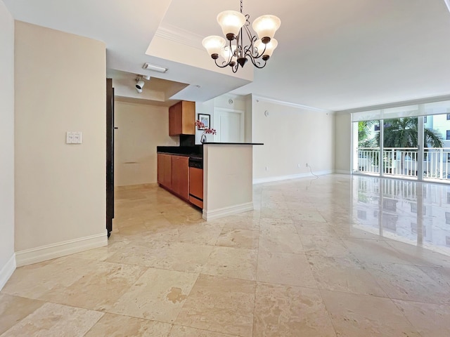 kitchen featuring pendant lighting, crown molding, a notable chandelier, a tray ceiling, and stainless steel dishwasher