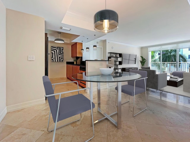 dining area featuring ornamental molding and a tray ceiling