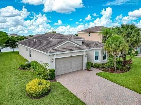 view of front of house with a garage and a front lawn