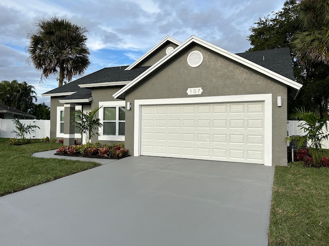 view of front of property featuring a front yard and a garage