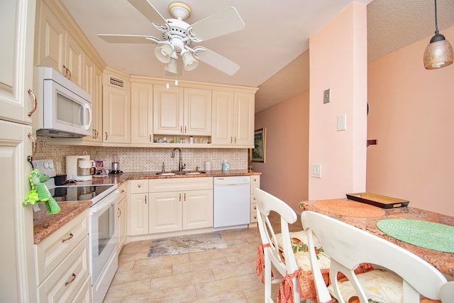 kitchen featuring ceiling fan, hanging light fixtures, sink, white appliances, and backsplash