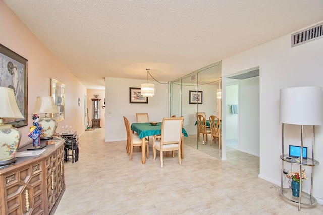 dining room with a textured ceiling