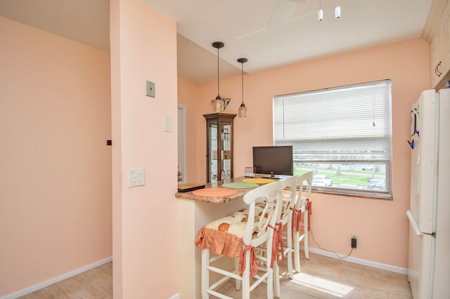 kitchen with pendant lighting and white refrigerator