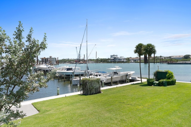 dock area with a yard and a water view