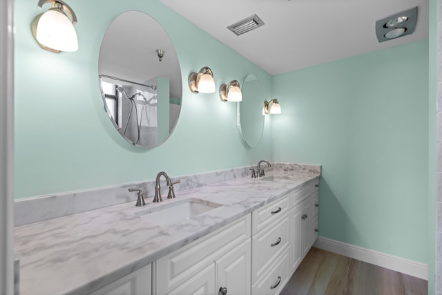 bathroom with vanity and hardwood / wood-style flooring